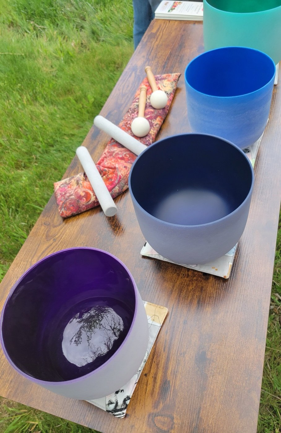 Crystal singing bowls on a wooden bench